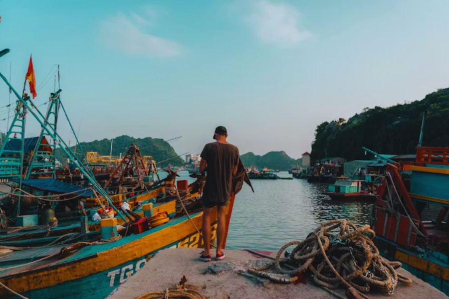 Solo traveler in Vietnam visiting a fishing village near Ha Long Bay